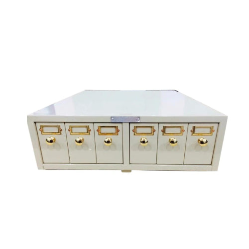 Front-facing studio view of a 4E's USA modular metal slide storage cabinet featuring six closed drawers with brass knobs and label holders.