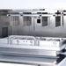 Studio product view of the internal chamber of a 4E's USA 32-throughput nucleic acid extraction system against a white background, highlighting its stainless steel housing and precision magnetic rod assembly
