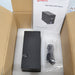 Top-down view of a 4E's USA CytoCube portable cell counter packed inside an open cardboard box with protective foam, showing the unit, an included power cable in a plastic bag, and the operating instructions manual