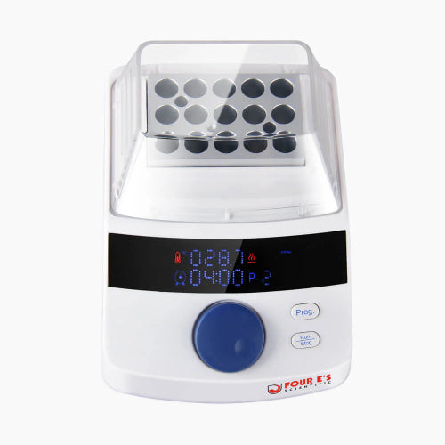 Studio top-down product view of a 4E's USA mini block heater with a clear removable non-heated lid and a loaded sample block against a white background, highlighting its white housing, multi-well metal block, digital LED display, and blue control dial