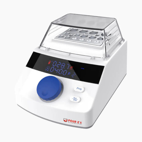 Studio low-angle product view of a 4E's USA mini block heater with a clear removable non-heated lid and a loaded sample block against a white background, highlighting its white housing, Four E's branding, digital LED panel, and blue control dial