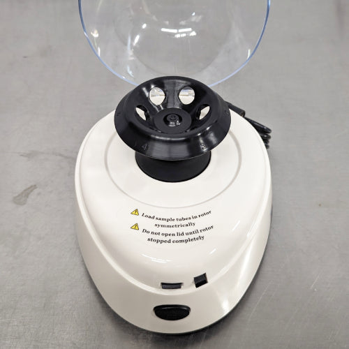 4E's USA brand new mini centrifuge ka open lid top view, jisme open transparent lid, microtube rotor slots, safety warning labels, aur housing base saaf dikhai de rahe hain.   