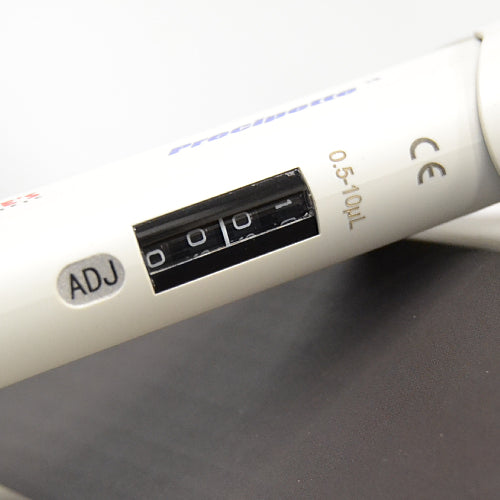 Close-up product view of the digital volume display window and calibration port on a 4E's USA Precipette 8-channel adjustable multichannel pipette (0.5-10uL), highlighting the white body and numerical readout against a neutral background