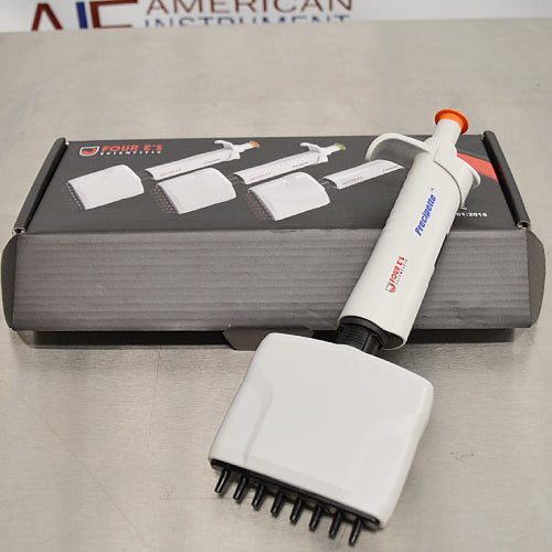 Product view of a 4E's USA Precipette 8-channel adjustable multichannel pipette (0.5-10uL) resting diagonally in front of its branded packaging box on a neutral surface, highlighting its white body and orange plunger cap