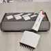 Product view of a 4E's USA Precipette 8-channel adjustable multichannel pipette (0.5-10uL) resting diagonally in front of its branded packaging box on a neutral surface, highlighting its white body and orange plunger cap