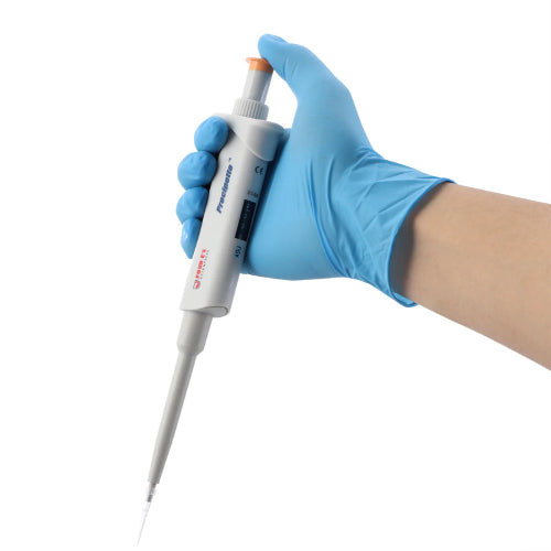 Studio product view of a 4E's USA Precipette adjustable pipette (0.1-2.0uL) held at an angle in a gloved hand against a white background, highlighting its ergonomic white body, orange plunger cap, and attached pipette tip