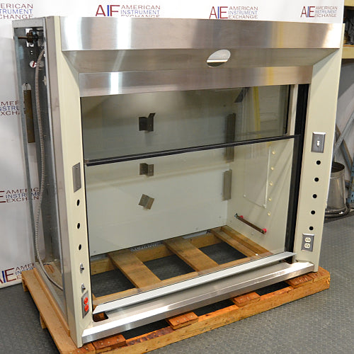 Front angled perspective view of a 5-foot Jamestown bench fume hood on a wooden pallet, showcasing its stainless steel top header, open glass sash workspace, and utility side panels with outlets and switches