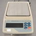 Straight-on studio view of an A&D GF-4000 precision balance on a metallic surface, featuring its square stainless steel weighing pan, light grey housing, digital display screen, and right-hand operational control buttons