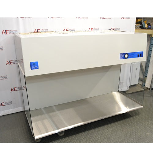 An alternative angle view of the Labconco Purifier Horizontal Clean Bench model 3873021, featuring the overhead white housing, expansive stainless steel work surface, and transparent side panels, positioned in front of an American Instrument Exchange backdrop.