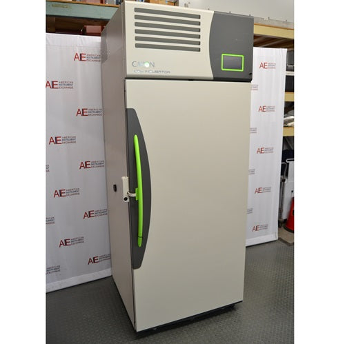 A slightly varied angle of the beige Caron 7401-33-22 reach-in CO₂ incubator, showcasing its top control console and green door handle against the American Instrument Exchange backdrop.