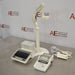 An alternative high-angled view of a Mettler Toledo SevenExcellence multiparameter meter setup on a stainless steel surface in front of an American Instrument Exchange backdrop, highlighting the touchscreen display unit, attached electrode arm, printer module, and connected cables.