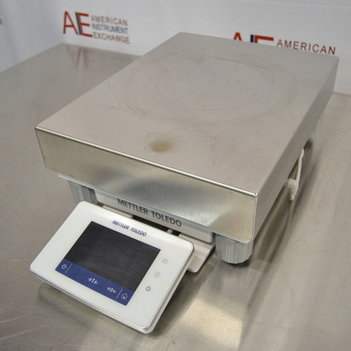 An alternative angled view of a Mettler Toledo XSR32001DR laboratory balance available from American Instrument Exchange, showing its large weighing pan and front-mounted digital touchscreen display.