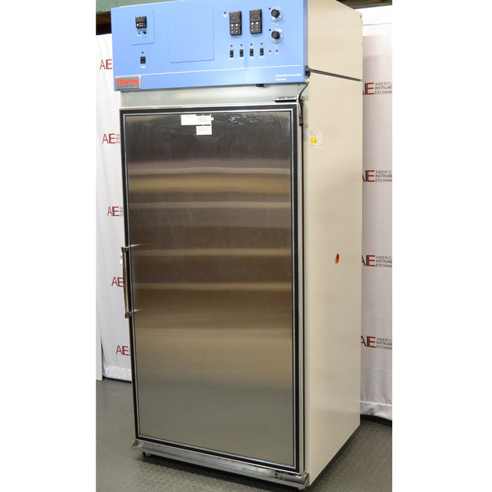 An alternative angled view of a Thermo Forma 3920 environmental chamber in front of an American Instrument Exchange backdrop, featuring a stainless steel door and a top control console.