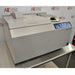 An alternative angled view of a Thermo Savant SpeedVac SPD2030 vacuum concentrator system on a stainless steel lab table, highlighting the front housing, control panel, and top cover assembly.