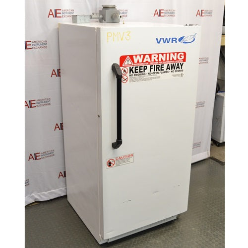 An alternative angled view of a VWR explosion-proof refrigerator available from American Instrument Exchange, showing its solid white exterior door, safety warning labels, and vertical handle.