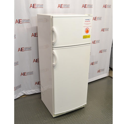 An alternative angled view of a VWR explosion-proof refrigerator/freezer combination unit, showing its white double-door exterior, curved vertical handles, and safety labels on the upper door.