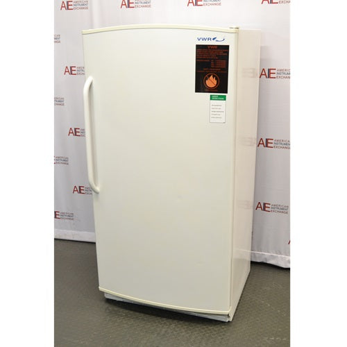 An alternative angled view of a VWR R421FA15 flammable material storage refrigerator available from American Instrument Exchange, showing the solid white exterior door, handle, and safety warning label.