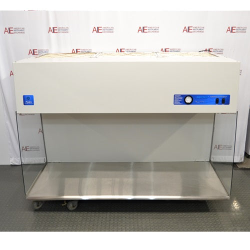 An angled view of the Labconco Purifier Horizontal Clean Bench model 3873021, showcasing the white overhead unit, stainless steel work area, and transparent side panels, positioned in front of an American Instrument Exchange backdrop.