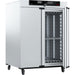 Angled view of Memmert UF1060plus forced convection universal oven with right door open showing interior shelving and wall racks