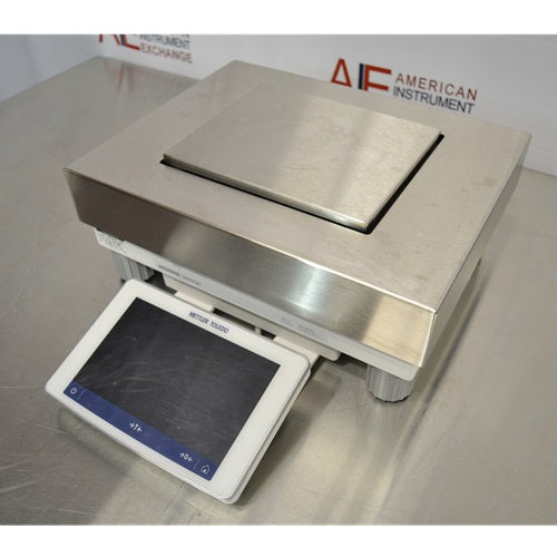 An alternative angled view of a Mettler Toledo XPR20002L Delta Range precision balance available from American Instrument Exchange, showing its square weighing pan and front-mounted digital touchscreen display.