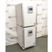 An angled view of two stacked PHCbi Cell-IQ series tri-gas cell culture incubators available from American Instrument Exchange, showing their control panels and white exterior.