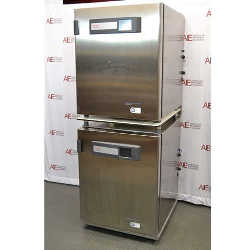 An angled view of two stacked stainless steel Thermo Scientific Heracell VIOS 250i CR CO2 incubators available from American Instrument Exchange, showing their control panels.