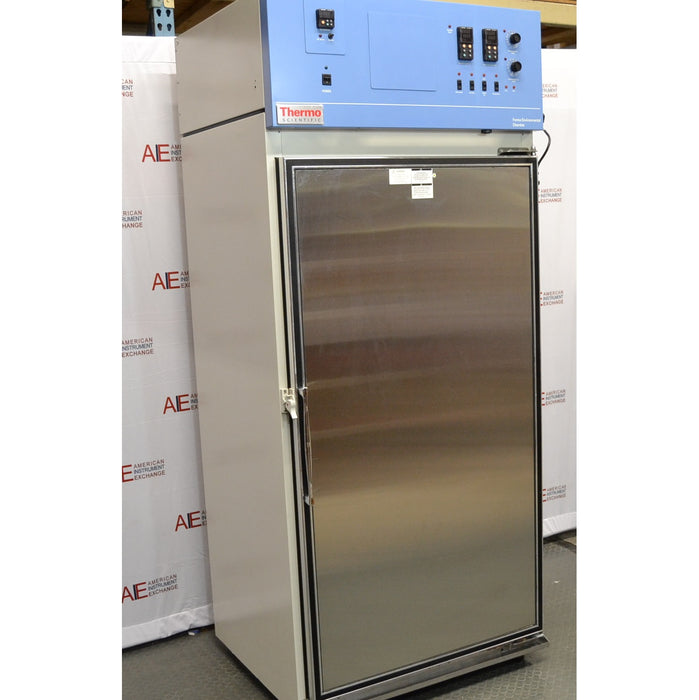 An alternative angled view of a Thermo Forma 3920 environmental chamber in front of an American Instrument Exchange backdrop, highlighting the side profile, stainless steel door, and blue control panel.