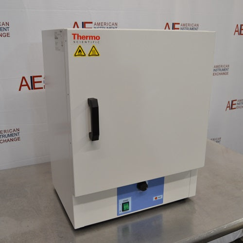 An angled view of a Thermo Scientific PR305225G Precision laboratory oven sitting on a stainless steel surface in front of an American Instrument Exchange backdrop, displaying its front door, vertical handle, left side panel, and blue control panel.