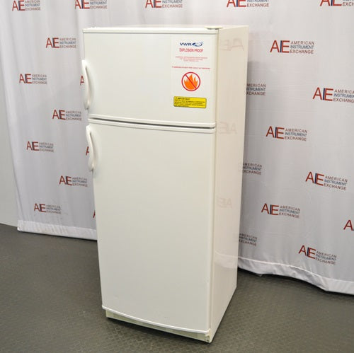 An alternative angled view of a VWR explosion-proof refrigerator/freezer combination unit, showing its white double-door exterior, recessed side handles, and safety warning labels.