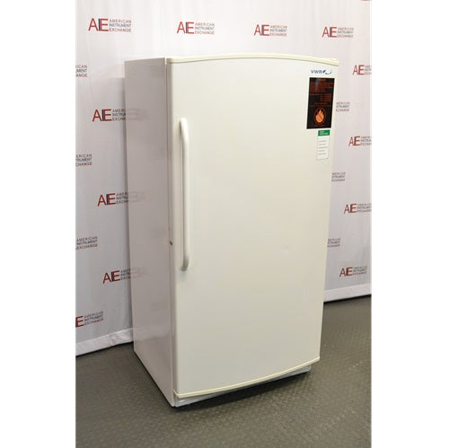 An angled view of a VWR R421FA15 flammable material storage refrigerator available from American Instrument Exchange, showing the solid white exterior door, handle, and safety warning label.