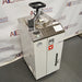 Angled view of Yamato Scientific SM510 vertical steam sterilizer autoclave with top clamp handle