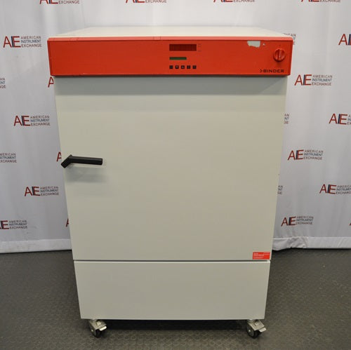 A white, upright Binder KB240 refrigerated incubator with a distinctive orange control panel, positioned in front of an American Instrument Exchange backdrop.