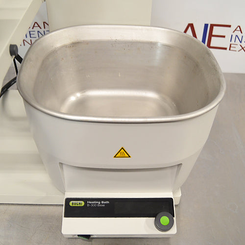 Buchi Rotovapor R-300 rotary evaporator system set on a table, with components including a glass flask, metal stands, and electronic interfaces.