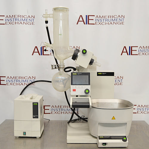 Buchi Rotovapor R-300 rotary evaporator system set on a table, with components including a glass flask, metal stands, and electronic interfaces.