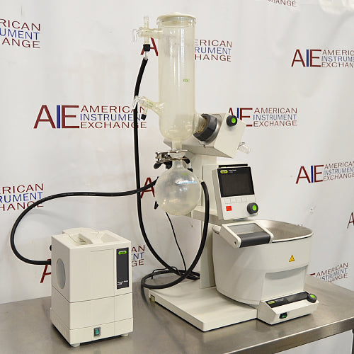 Buchi Rotovapor R-300 rotary evaporator system set on a table, with components including a glass flask, metal stands, and electronic interfaces.

