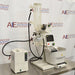 Buchi Rotovapor R-300 rotary evaporator system set on a table, with components including a glass flask, metal stands, and electronic interfaces.

