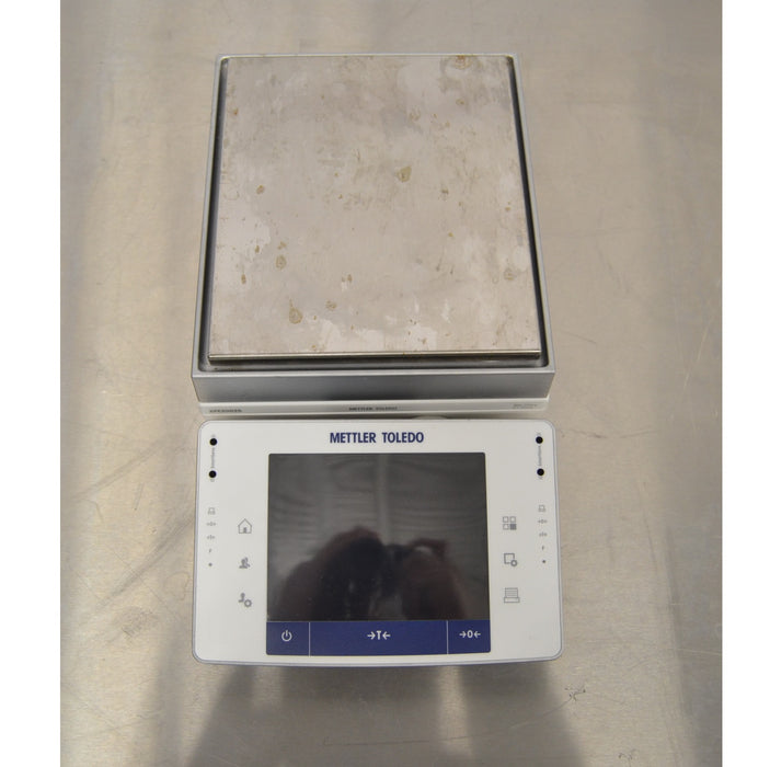 Direct top-down overhead view of the Mettler Toledo XPE2002S precision balance showing the touchscreen terminal interface and square stainless steel weighing pan.