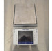 Direct top-down overhead view of the Mettler Toledo XPE2002S precision balance showing the touchscreen terminal interface and square stainless steel weighing pan.