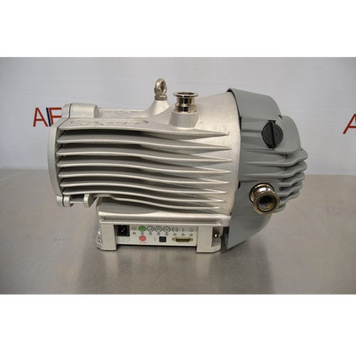 A side-profile view of an Edwards nXDS 10i dry scroll vacuum pump, showcasing its metallic ribbed housing, intake/exhaust ports, and base-mounted control interface.