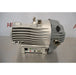 A side-profile view of an Edwards nXDS 10i dry scroll vacuum pump, showcasing its metallic ribbed housing, intake/exhaust ports, and base-mounted control interface.