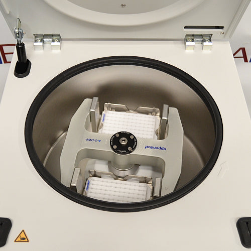 an Eppendorf Centrifuge 5804 on a textured surface with a white housing, closed lid, and blue control panel.