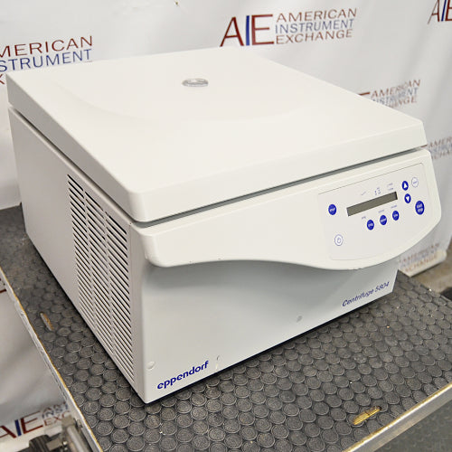 an Eppendorf Centrifuge 5804 on a textured surface with a white housing, closed lid, and blue control panel.
