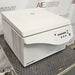 an Eppendorf Centrifuge 5804 on a textured surface with a white housing, closed lid, and blue control panel.