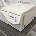 an Eppendorf Centrifuge 5804 on a textured surface with a white housing, closed lid, and blue control panel.
