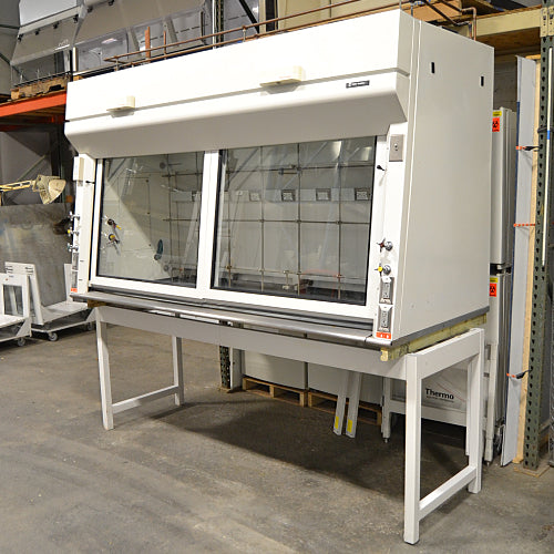 A white Fisher Hamilton 8' Chemical Fume Hood with a base stand, featuring a glass sash, a white epoxy work surface, and various fixtures such as monkey bars and external duplex outlets.