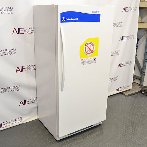 Three-quarter left-angled studio view of a Fisher Isotemp laboratory refrigerator model 17LREEFSA standing upright on a grey floor against a branded backdrop, showcasing its white exterior cabinet, front door with vertical handle, Fisher Scientific branding, and safety warning stickers