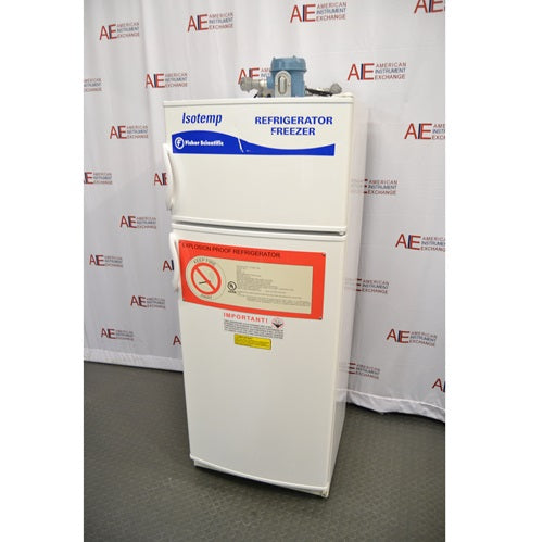 An alternative angled view of a Fisher Scientific Isotemp explosion-proof laboratory refrigerator/freezer combination unit, showing its white double-door exterior, warning labels, and top-mounted compressor housing.