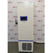 A white, upright Fisherbrand Isotemp ultra-low temperature freezer with a blue digital control panel and side handle, displayed in front of an American Instrument Exchange backdrop.