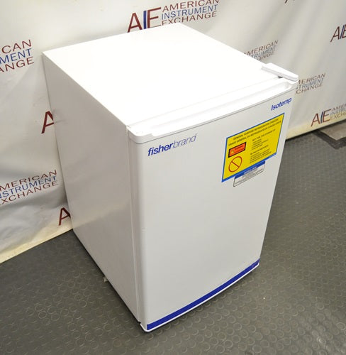 Angled front and side view of a white Fisherbrand Isotemp undercounter general-purpose laboratory unit with safety warning label.