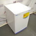 Angled front and side view of a white Fisherbrand Isotemp undercounter general-purpose laboratory unit with safety warning label.